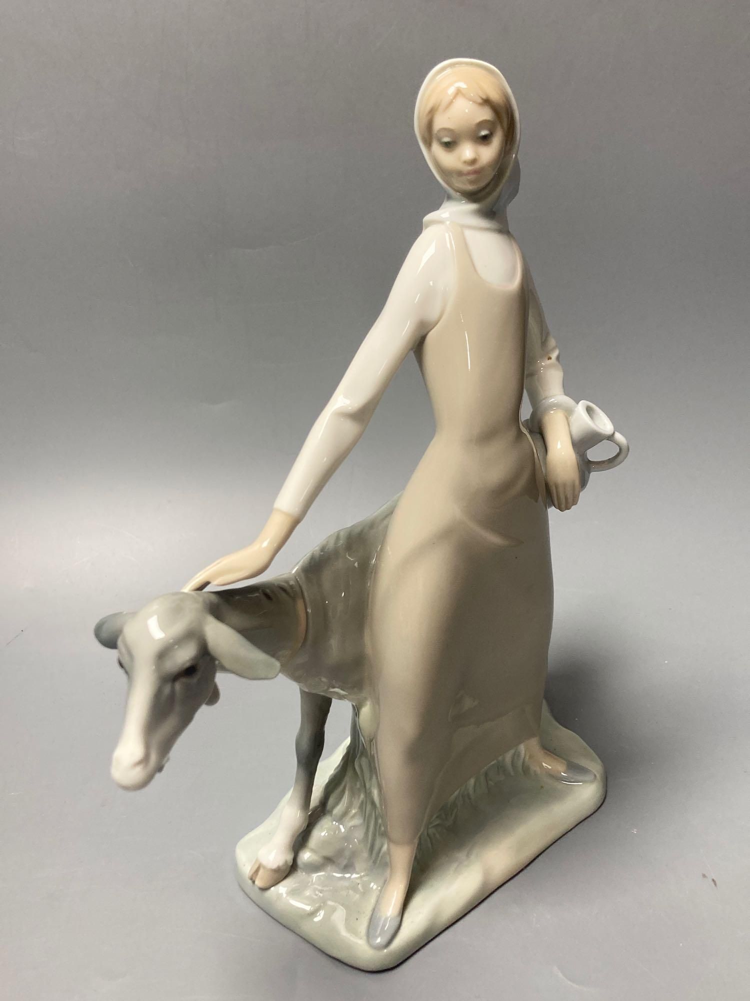 Three Lladro figures, largest 29cm, A Nao seated cherub and a Beswick horse